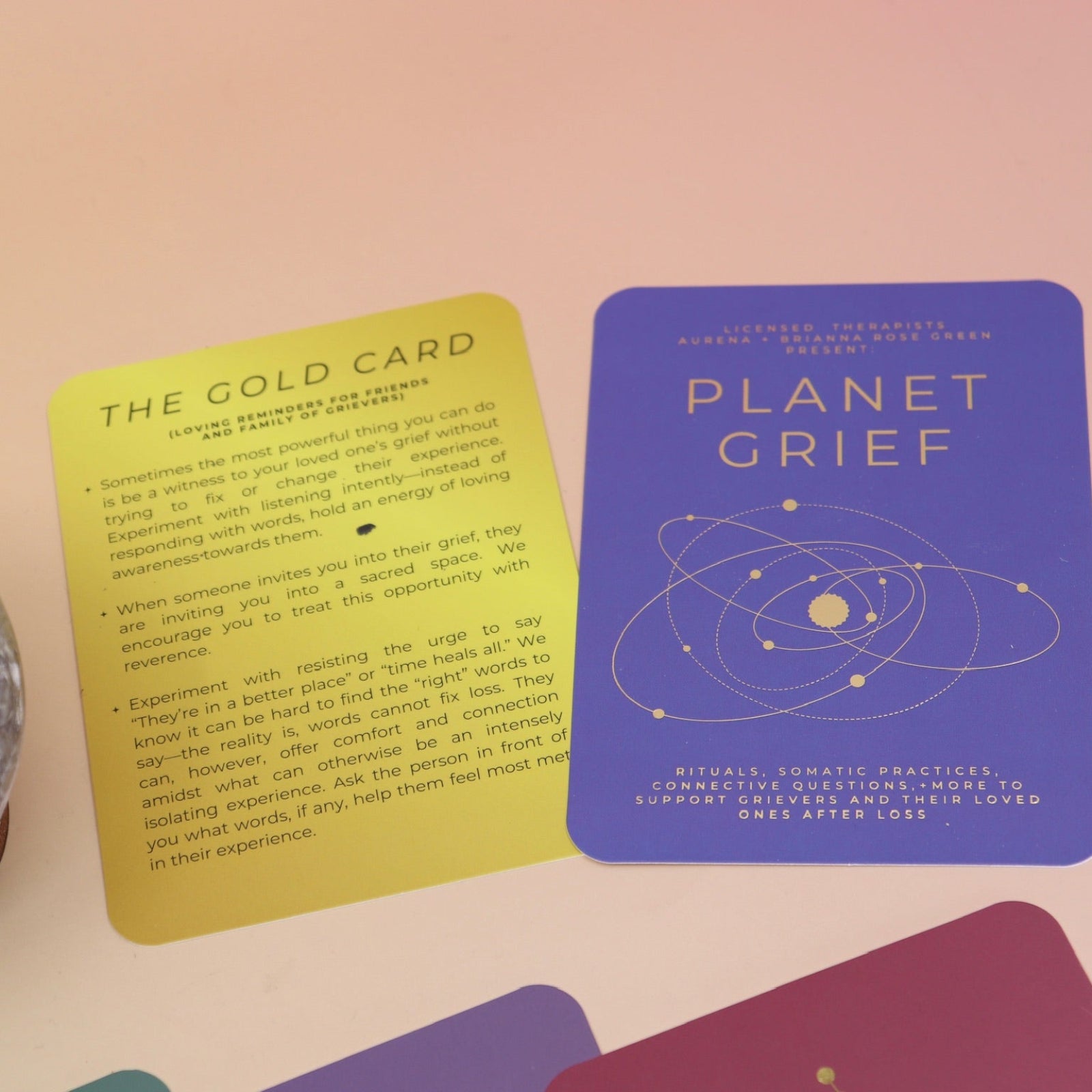 The contents of the Planet Grief Card Deck Bereavement Resource on a pink and yellow background.