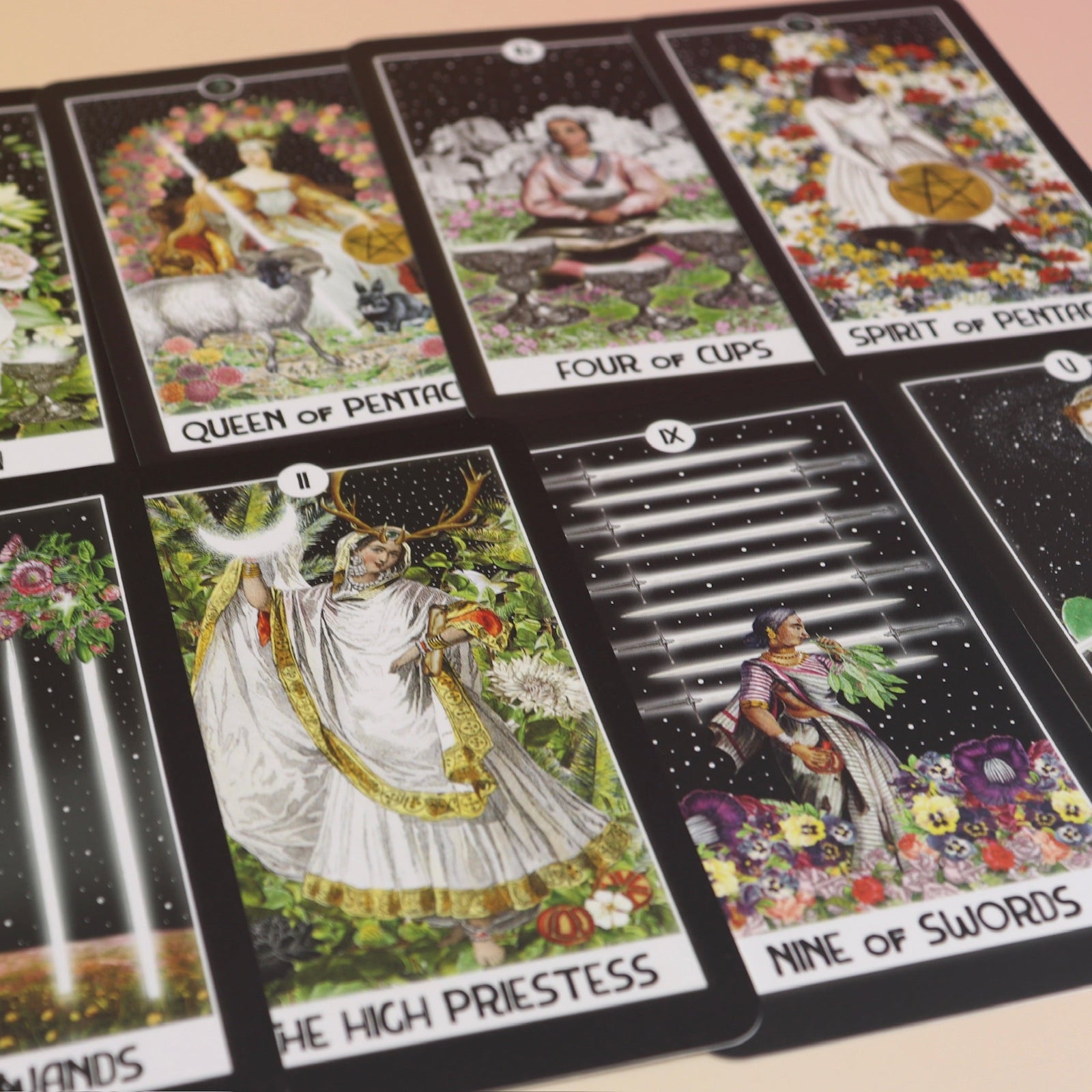 The contents of the Intuitive Night Goddess Tarot Deck on a pink and yellow background.