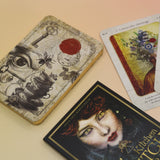 The contents of the Kitchen Witch Oracle Deck on a pink and yellow background.