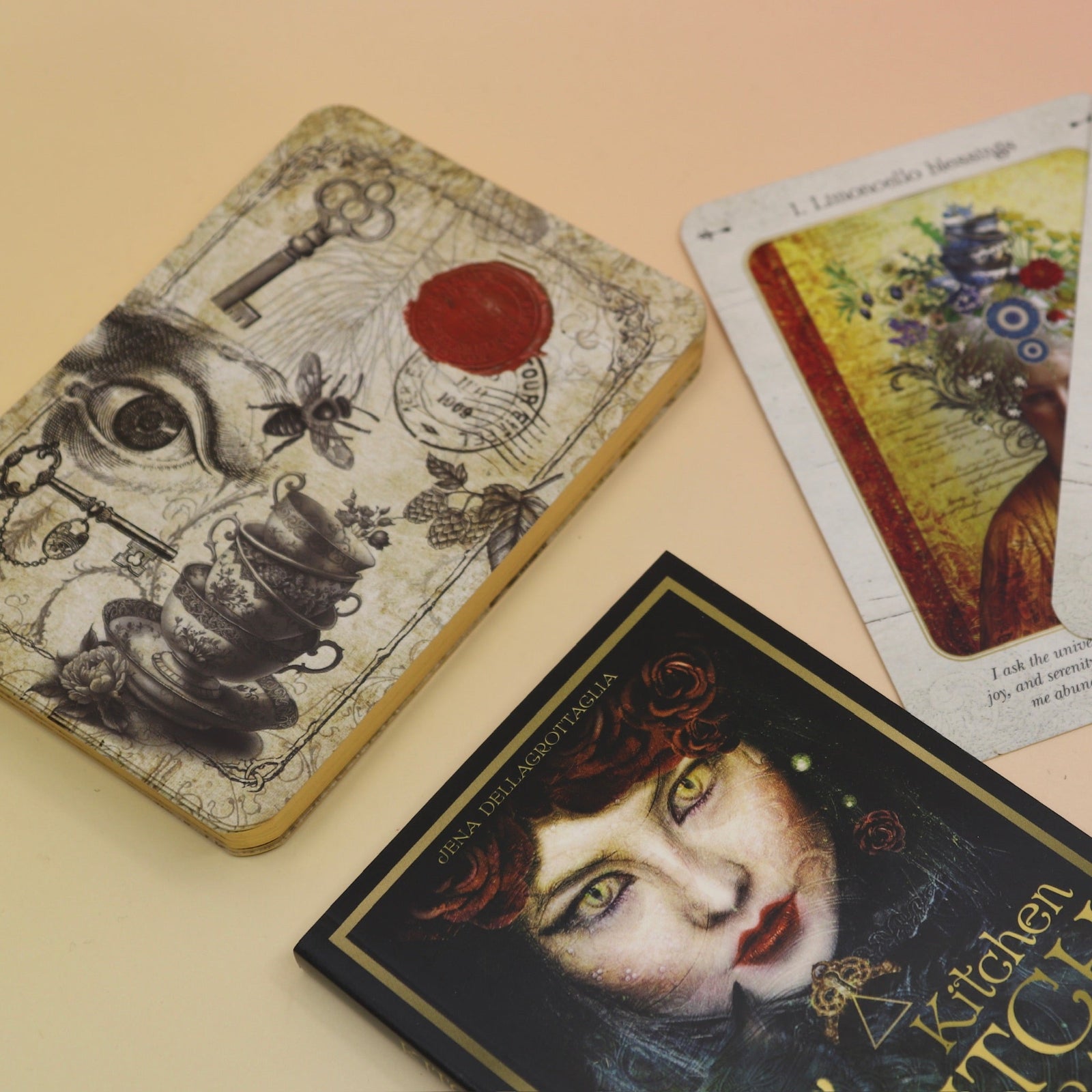 The contents of the Kitchen Witch Oracle Deck on a pink and yellow background.