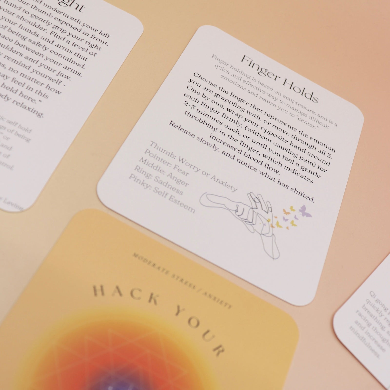 The contents of the Hack Your Nervous System card deck on a pink and yellow background.