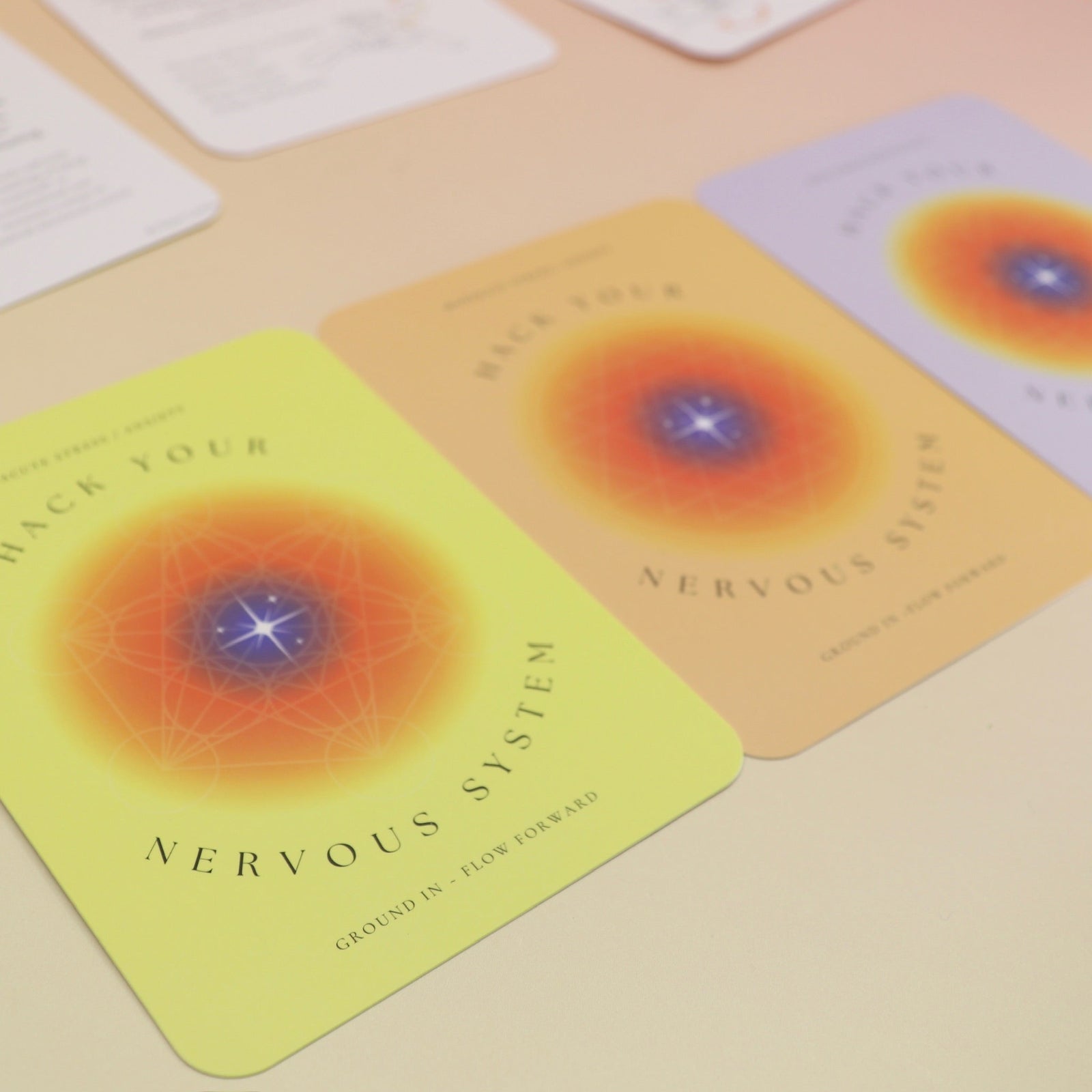 The contents of the Hack Your Nervous System card deck on a pink and yellow background.