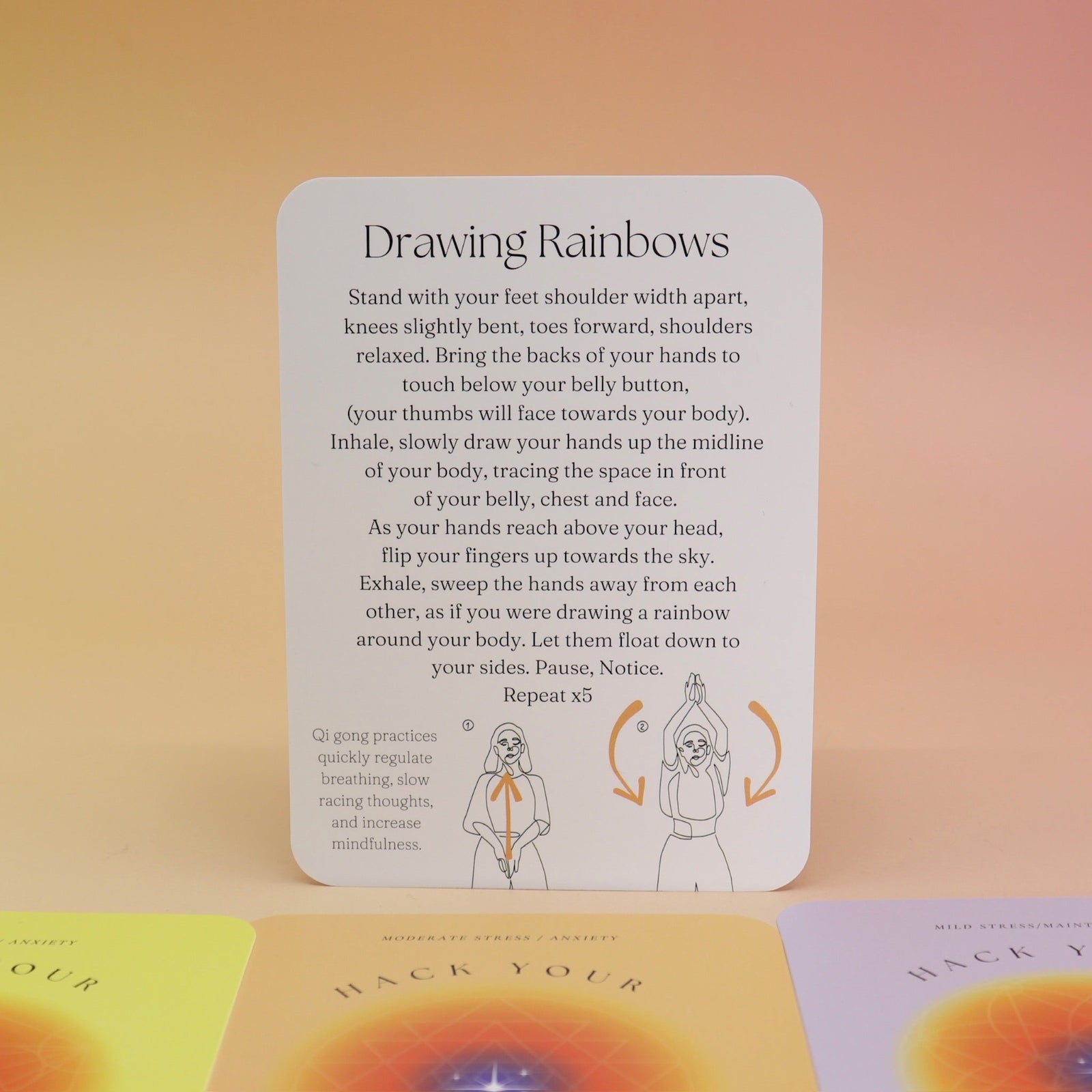 The contents of the Hack Your Nervous System card deck on a pink and yellow background.
