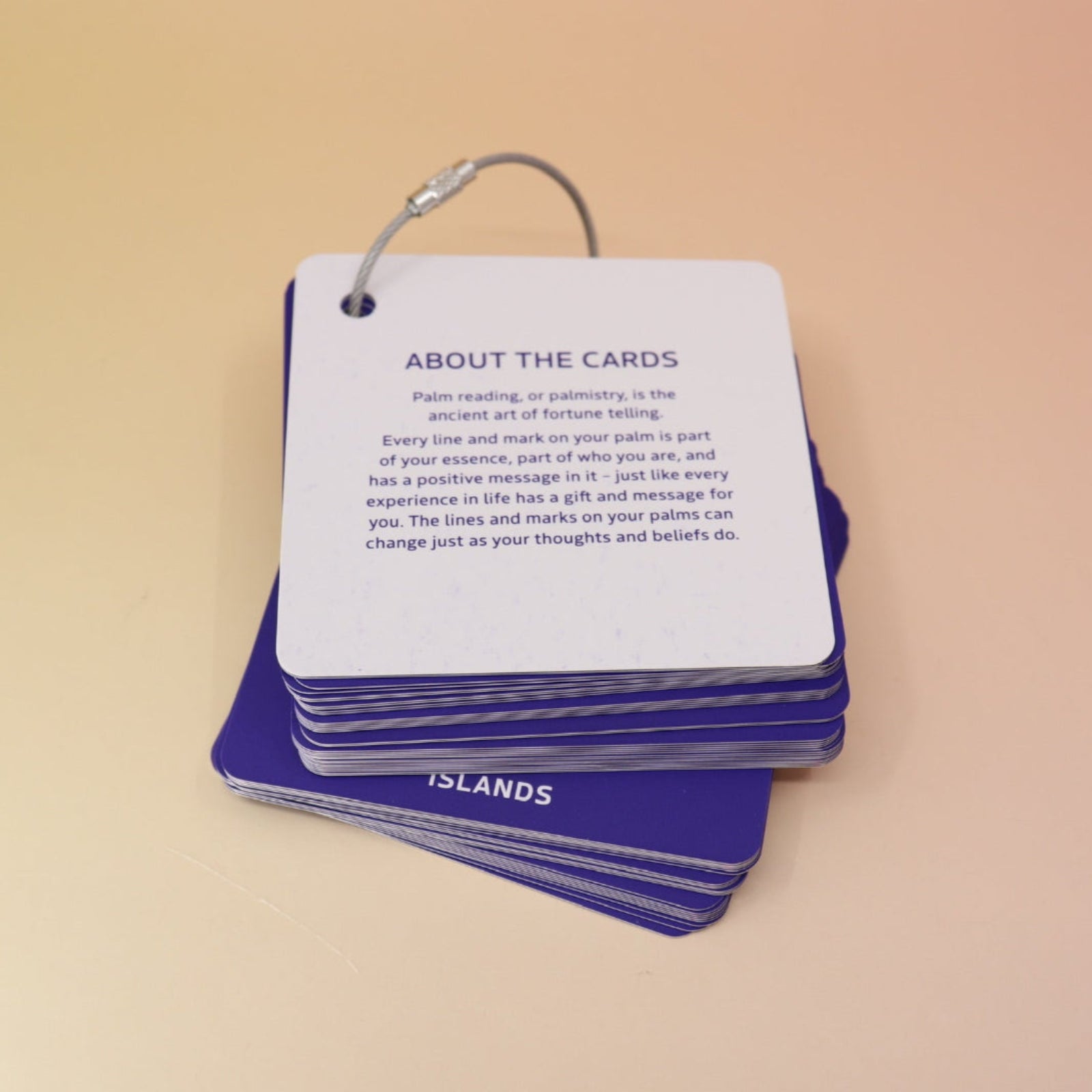 The flashcards from the Palmistry Flashcards by Anna Comerford on a pink and yellow background.