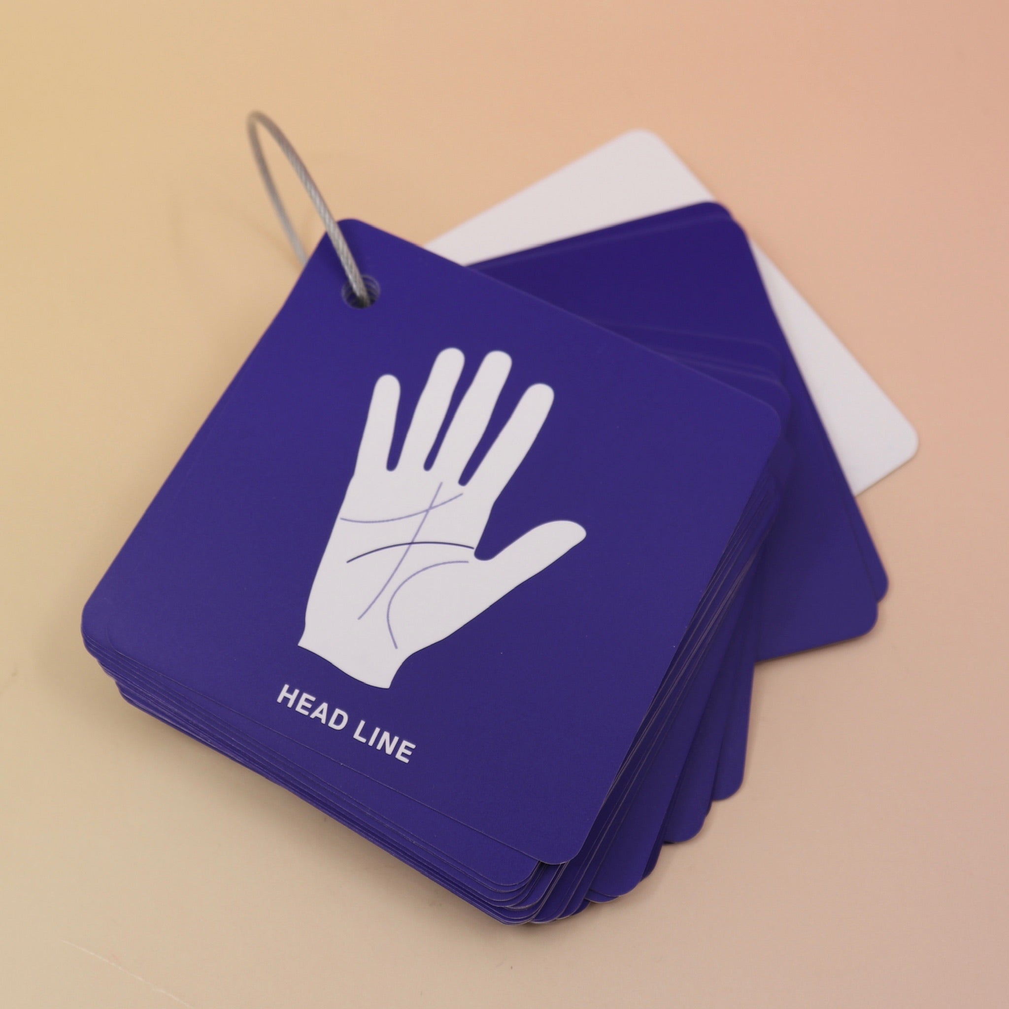 The flashcards from the Palmistry Flashcards by Anna Comerford on a pink and yellow background.