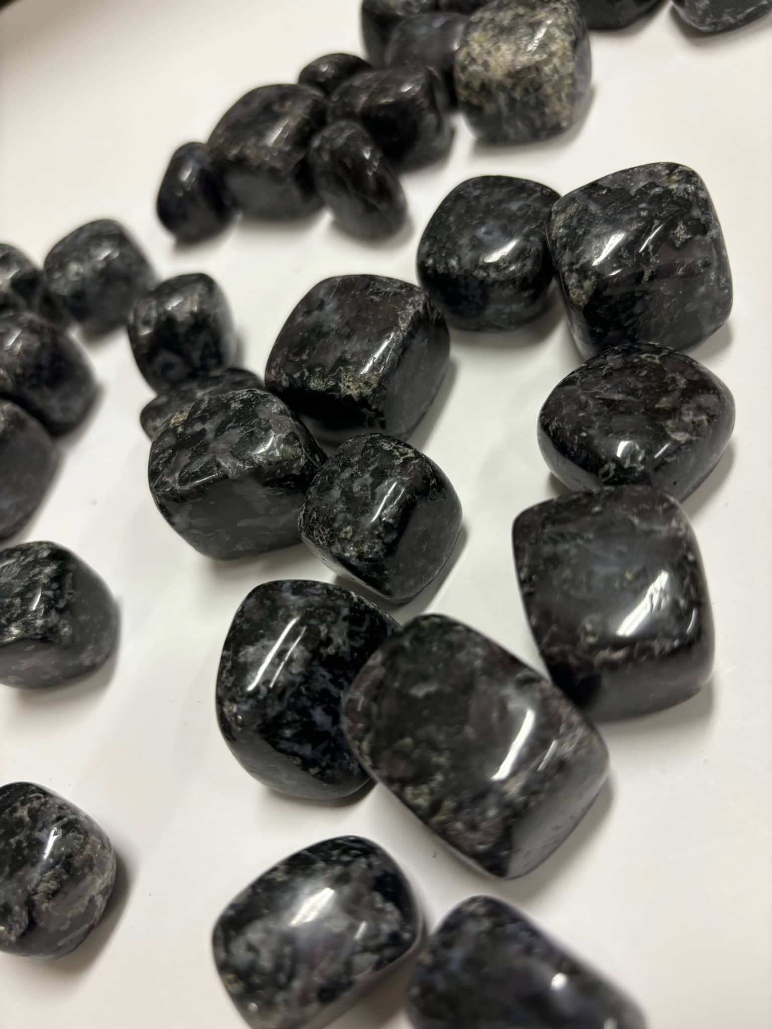 Close-up of large Indigo Gabbro tumbles showing natural swirling patterns