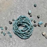Larimar stone bracelet on a gray surface