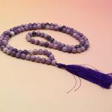 Lepidolite 108 Mala Necklace on pink and orange background