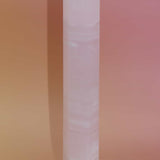 Crystal obelisk on a gradient pink and orange background