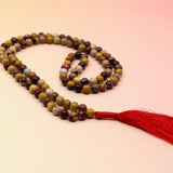 Mookaite Jasper 108 Mala Necklace on pink and orange background