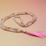 Morganite 108 Mala Necklace on pink and orange background