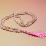 Morganite 108 Mala Necklace on pink and orange background
