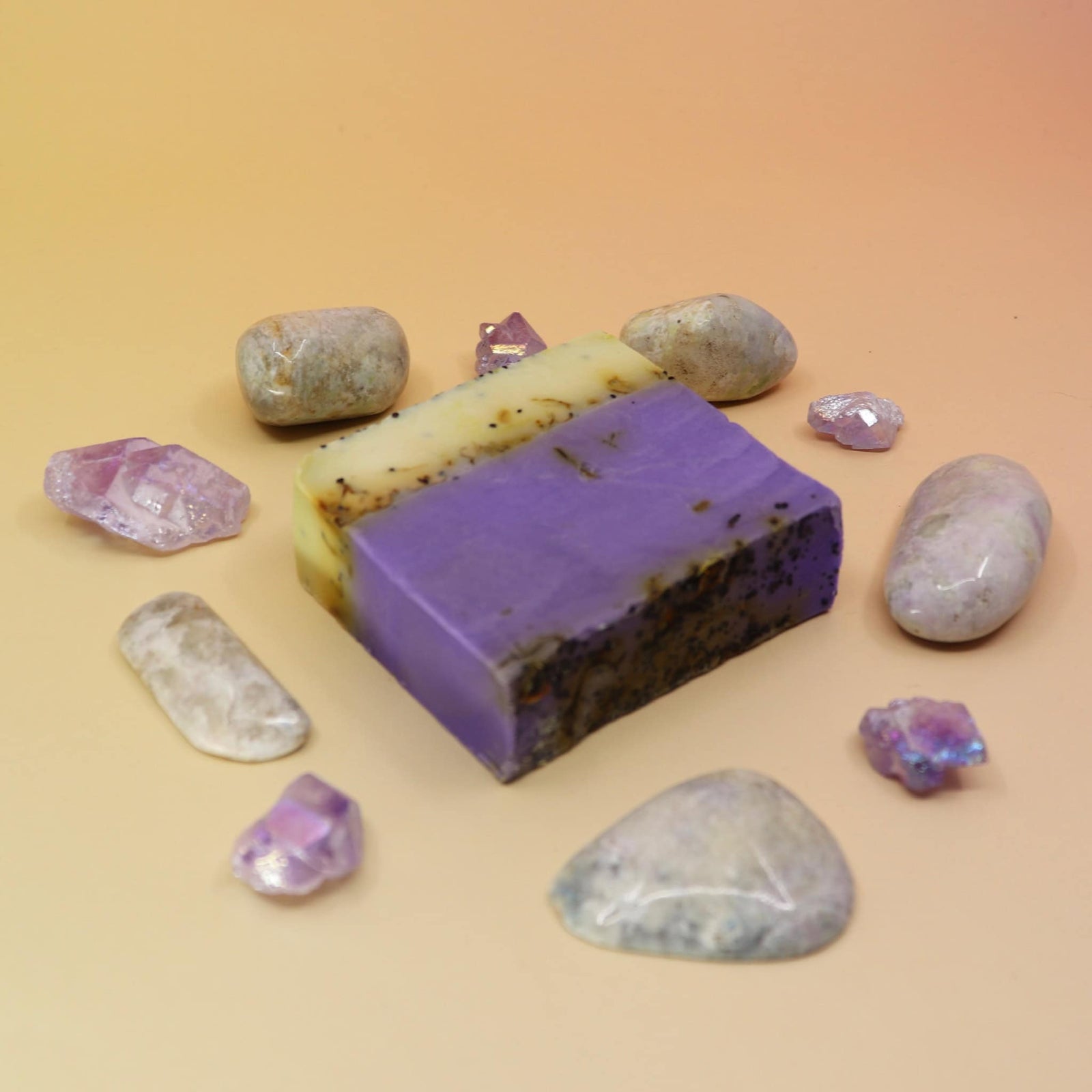 Purple soap bar with natural stones on a beige background