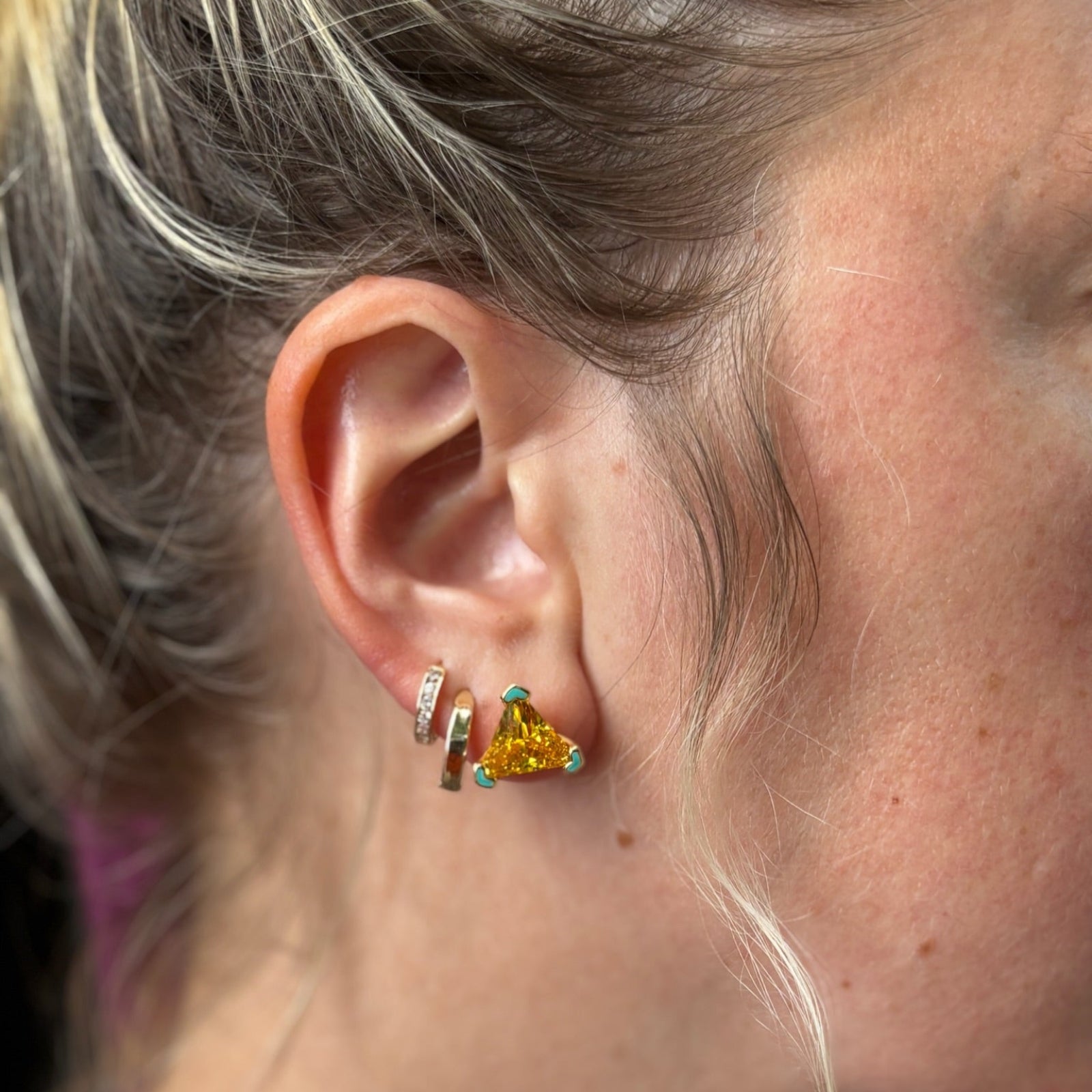 close up of models ear with 3 piercings featuring the 1 own it stud earring