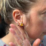 hand holding back of hear to showcase the own it stud