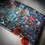 Sunglasses with red lenses on an open book with colorful illustrations