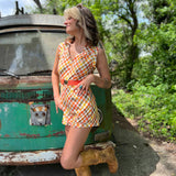 girl in 1970s Gingham Belted Romper in front of green VW vintage bus