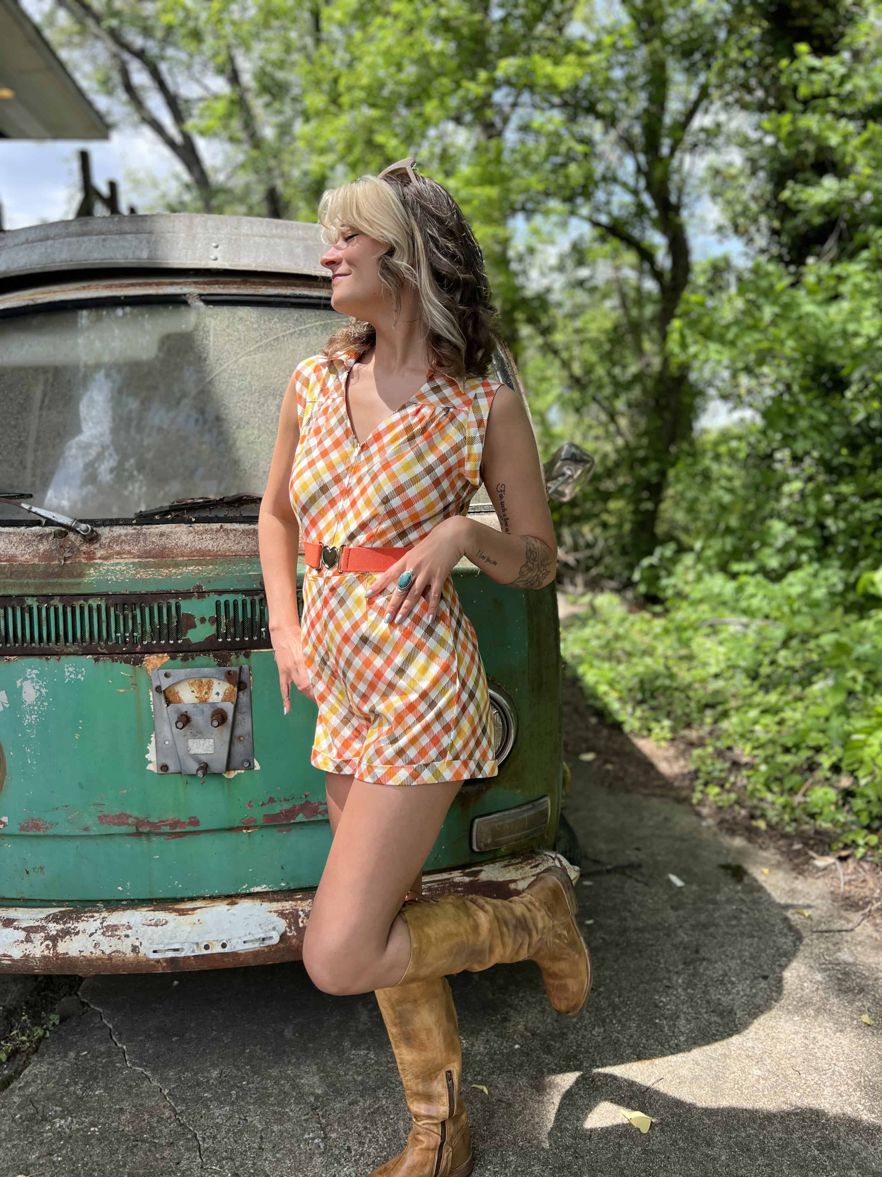 girl in 1970s Gingham Belted Romper in front of green VW vintage bus