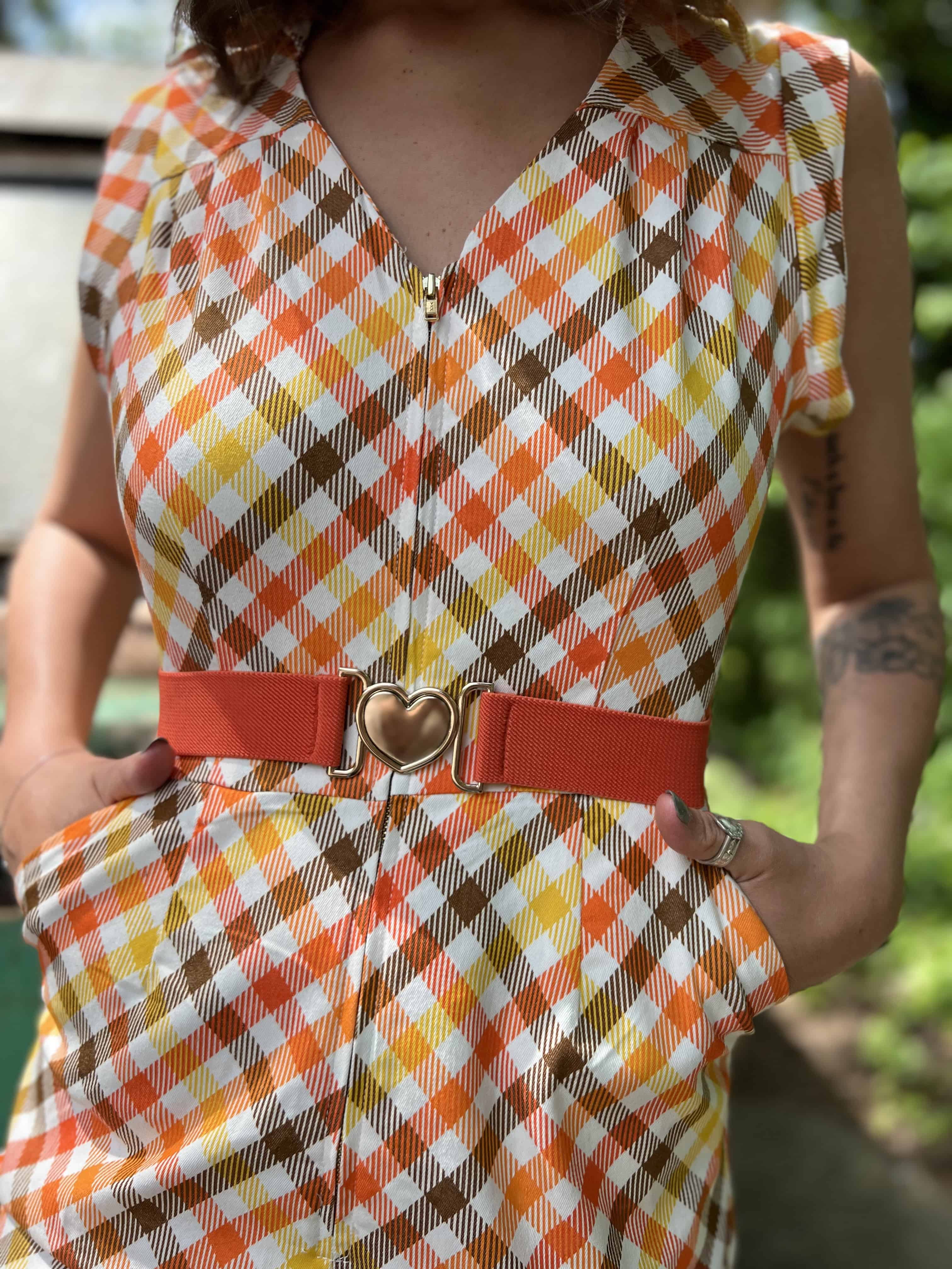 girl in 1970s Gingham Belted Romper in front of green VW vintage bus