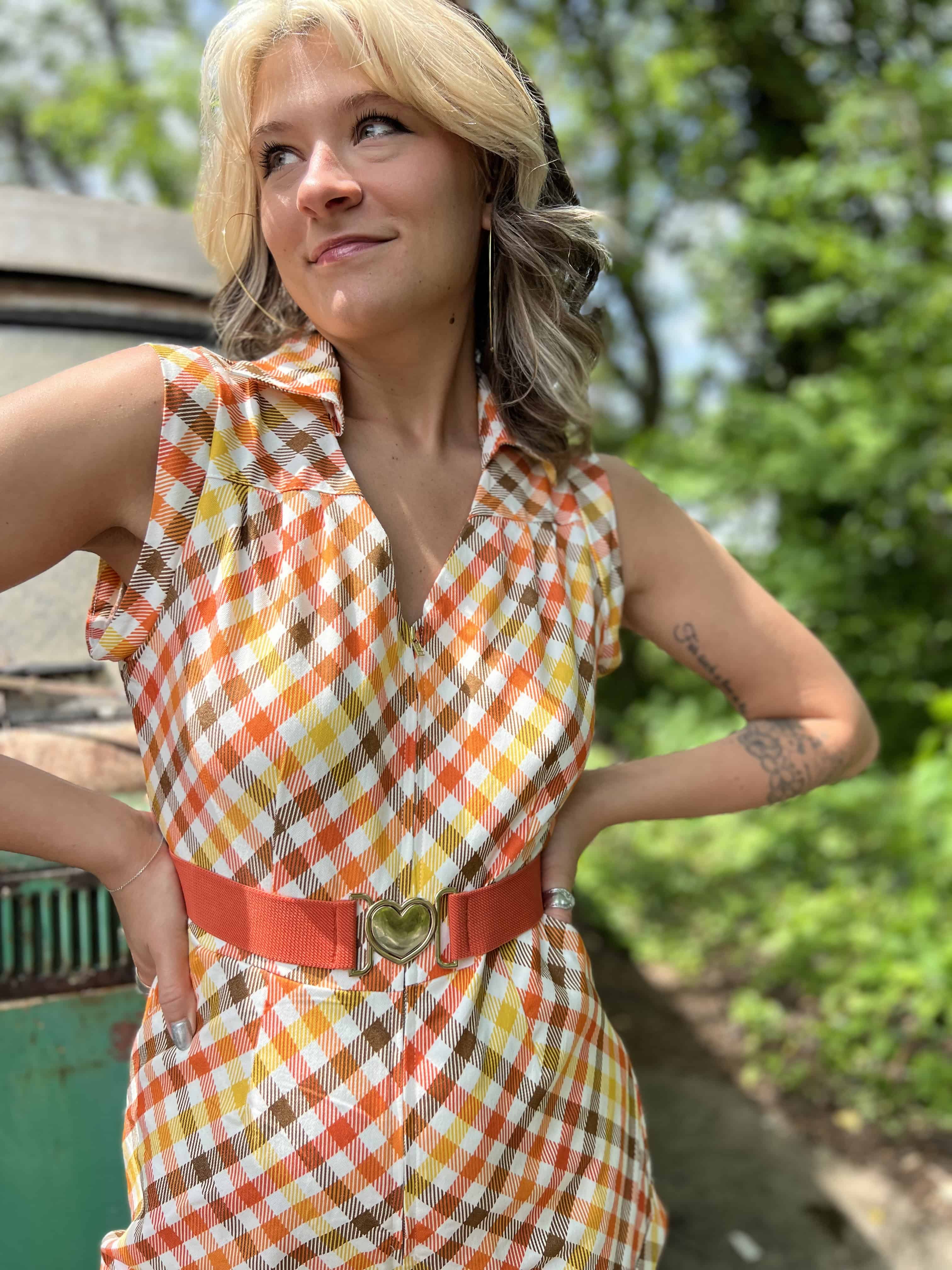 girl in 1970s Gingham Belted Romper in front of green VW vintage bus