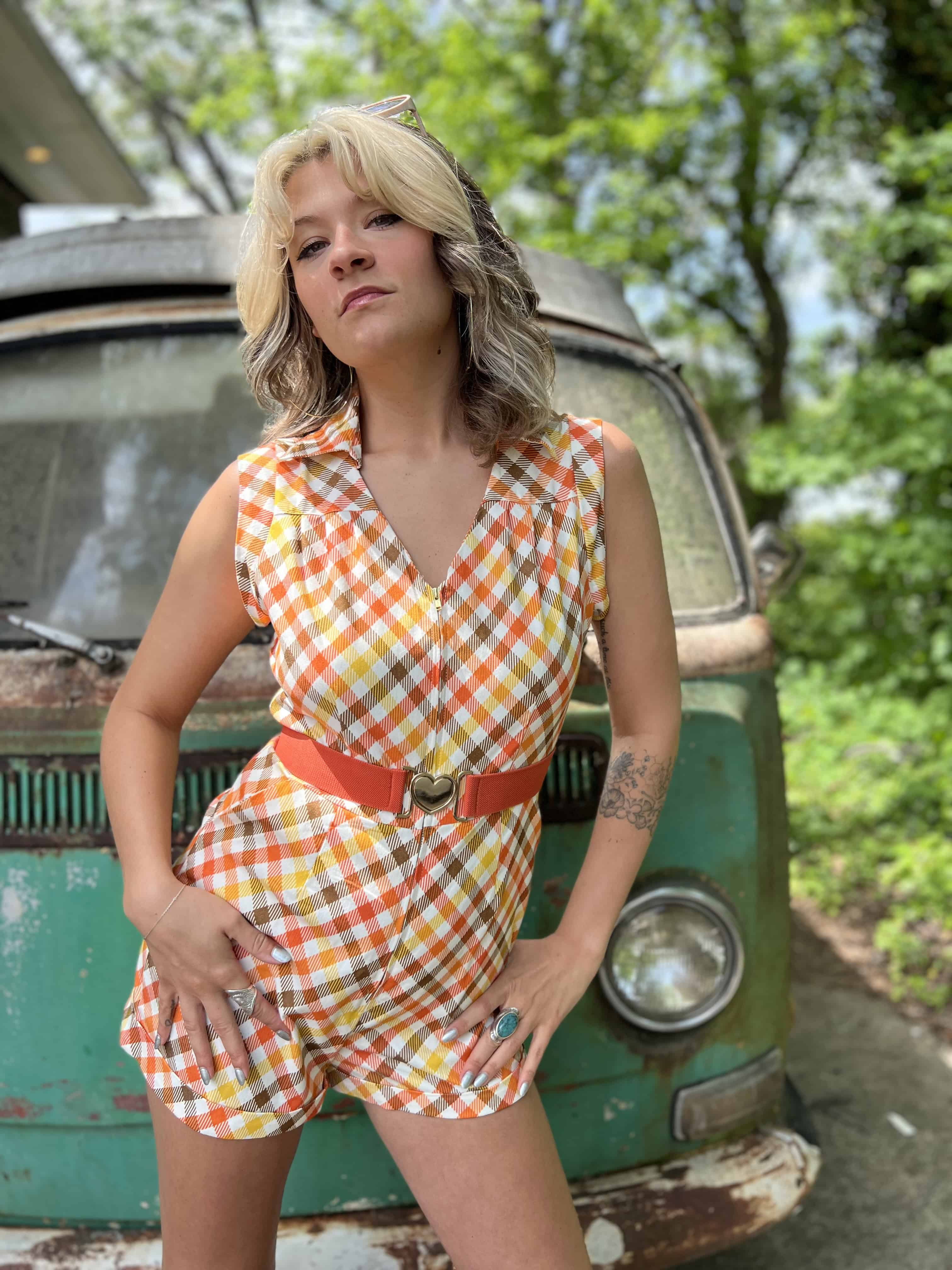 girl in 1970s Gingham Belted Romper in front of green VW vintage bus
