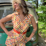 girl in 1970s Gingham Belted Romper in front of green VW vintage bus