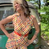 girl in 1970s Gingham Belted Romper in front of green VW vintage bus