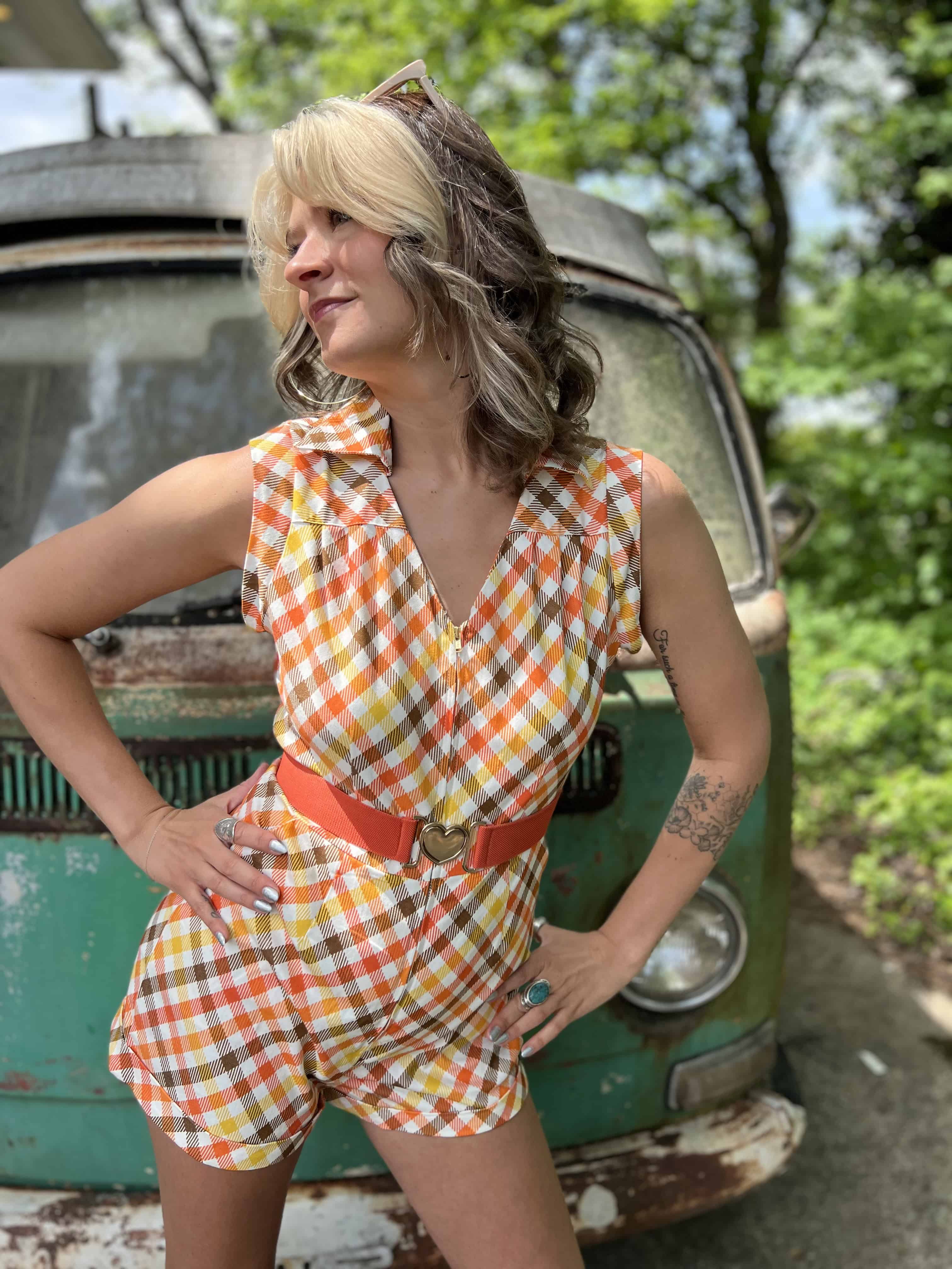 girl in 1970s Gingham Belted Romper in front of green VW vintage bus