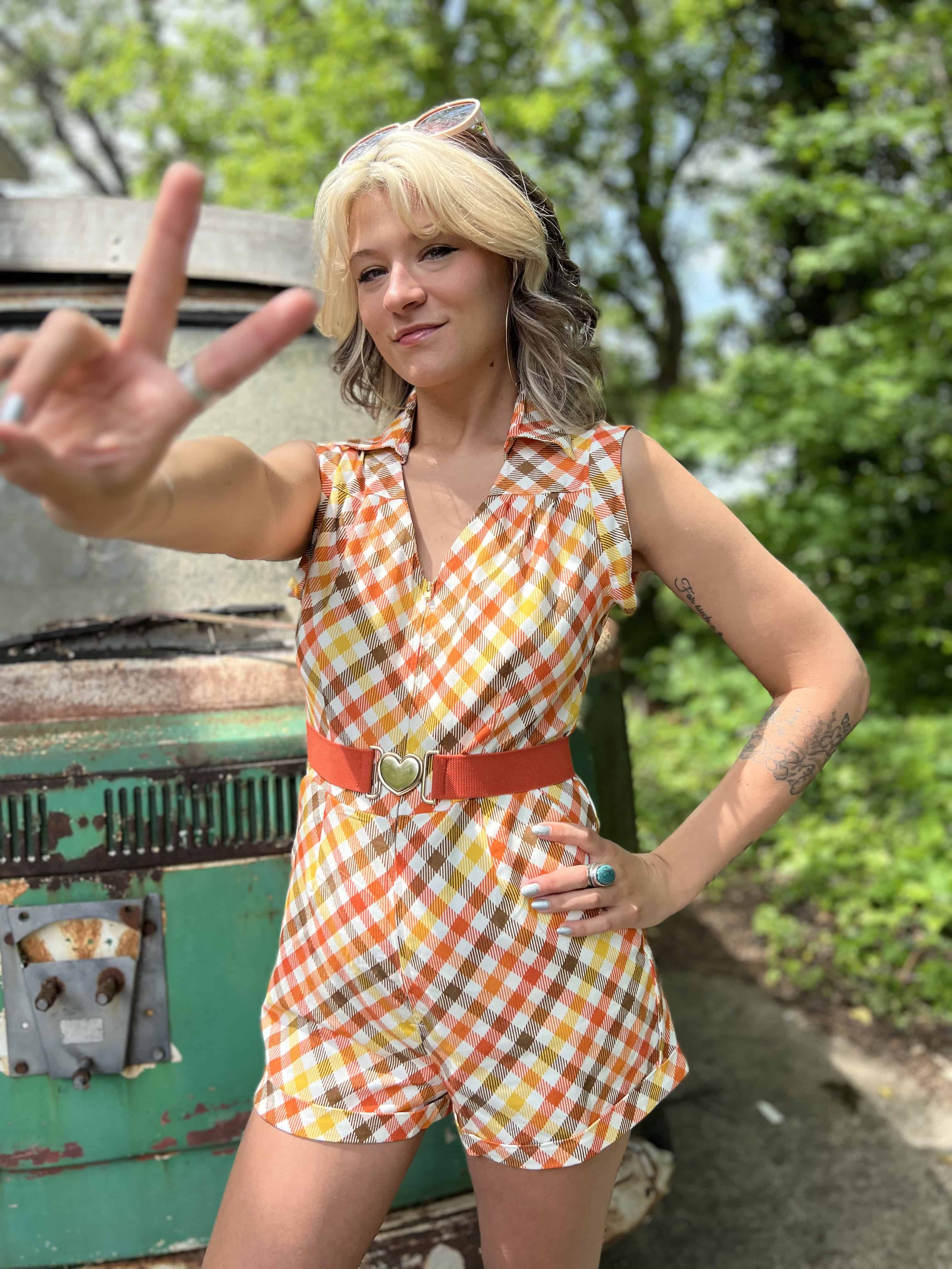 girl in 1970s Gingham Belted Romper in front of green VW vintage bus