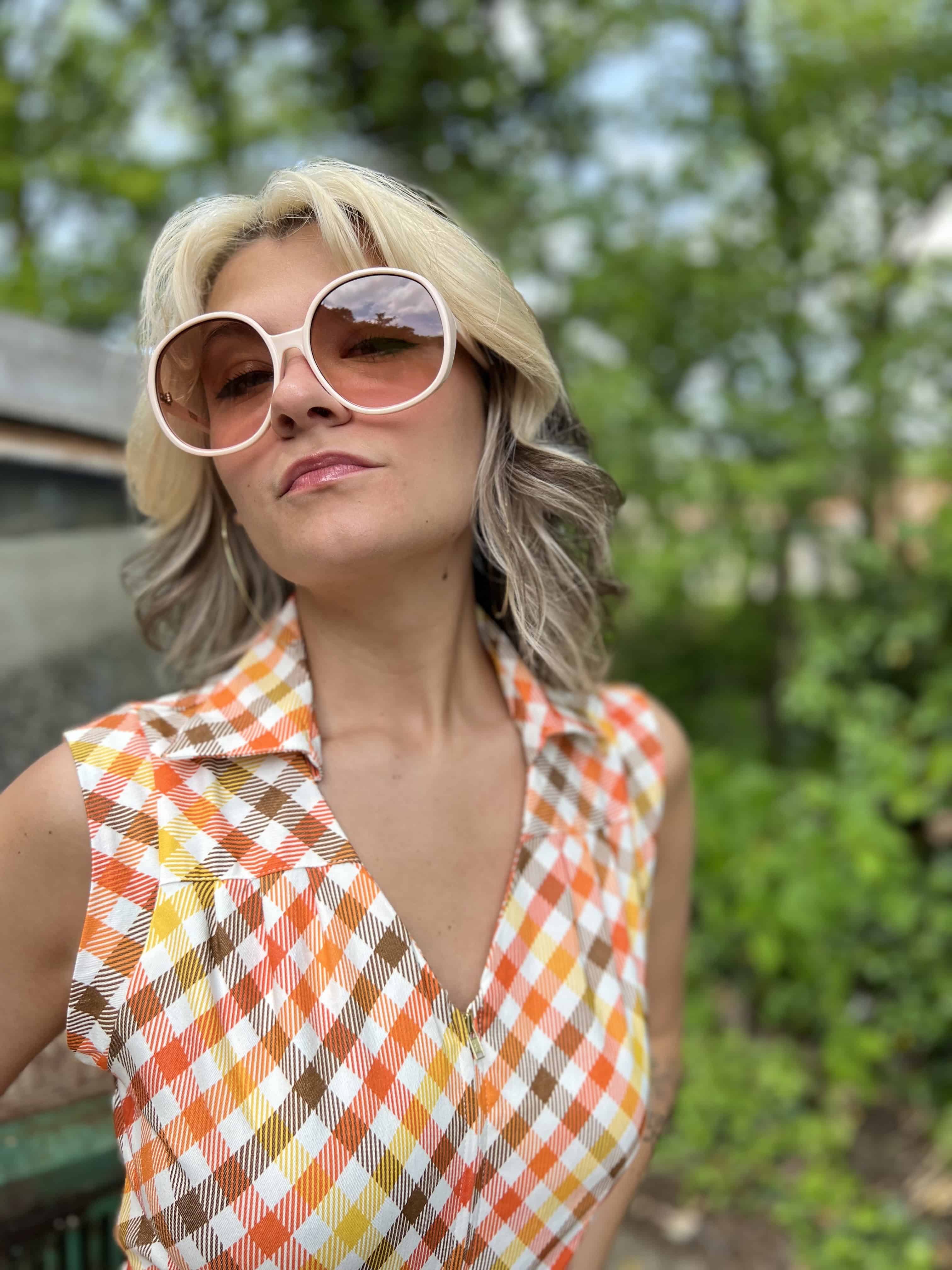 girl in 1970s Gingham Belted Romper in front of green VW vintage bus