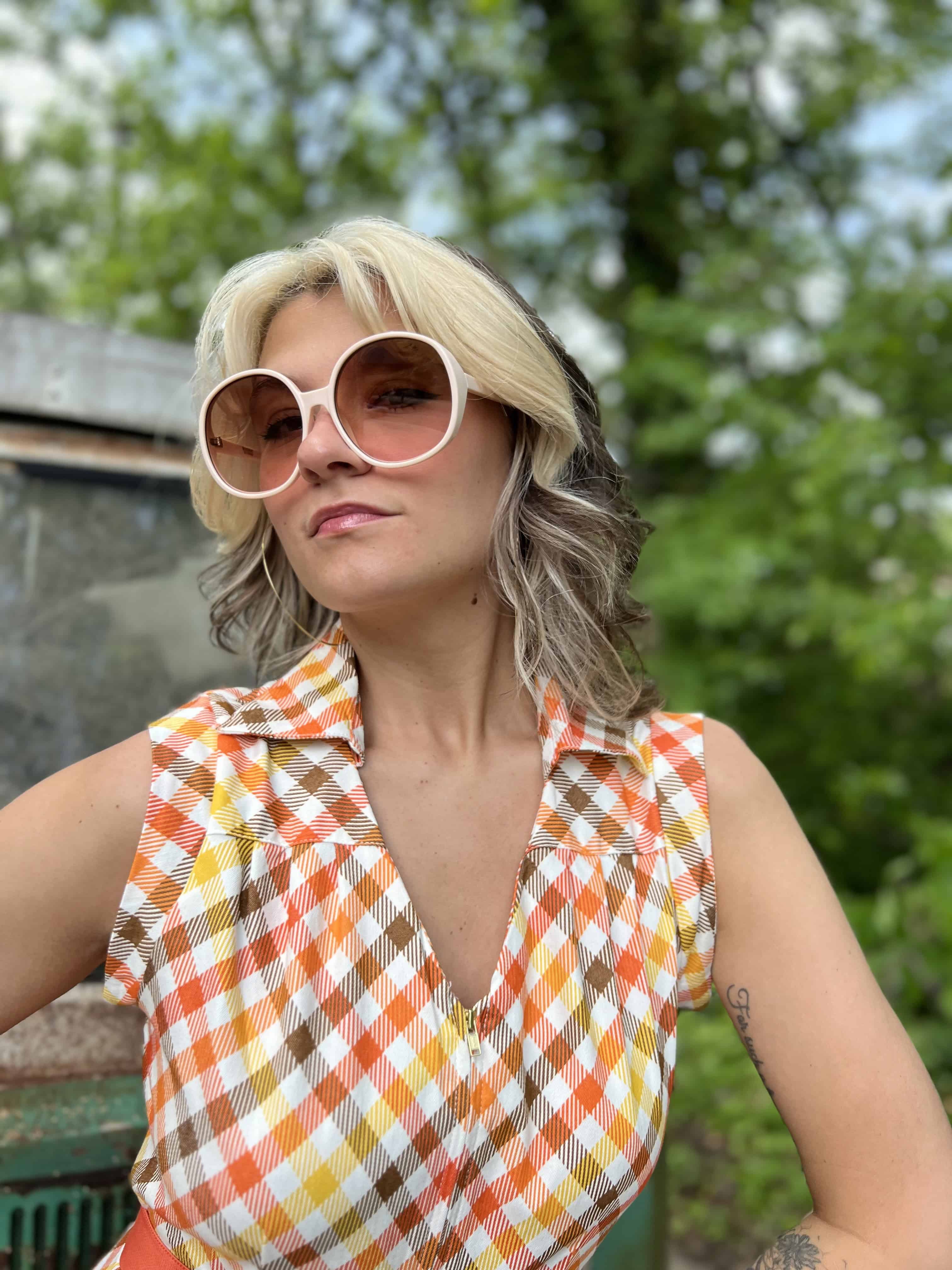 girl in 1970s Gingham Belted Romper in front of green VW vintage bus