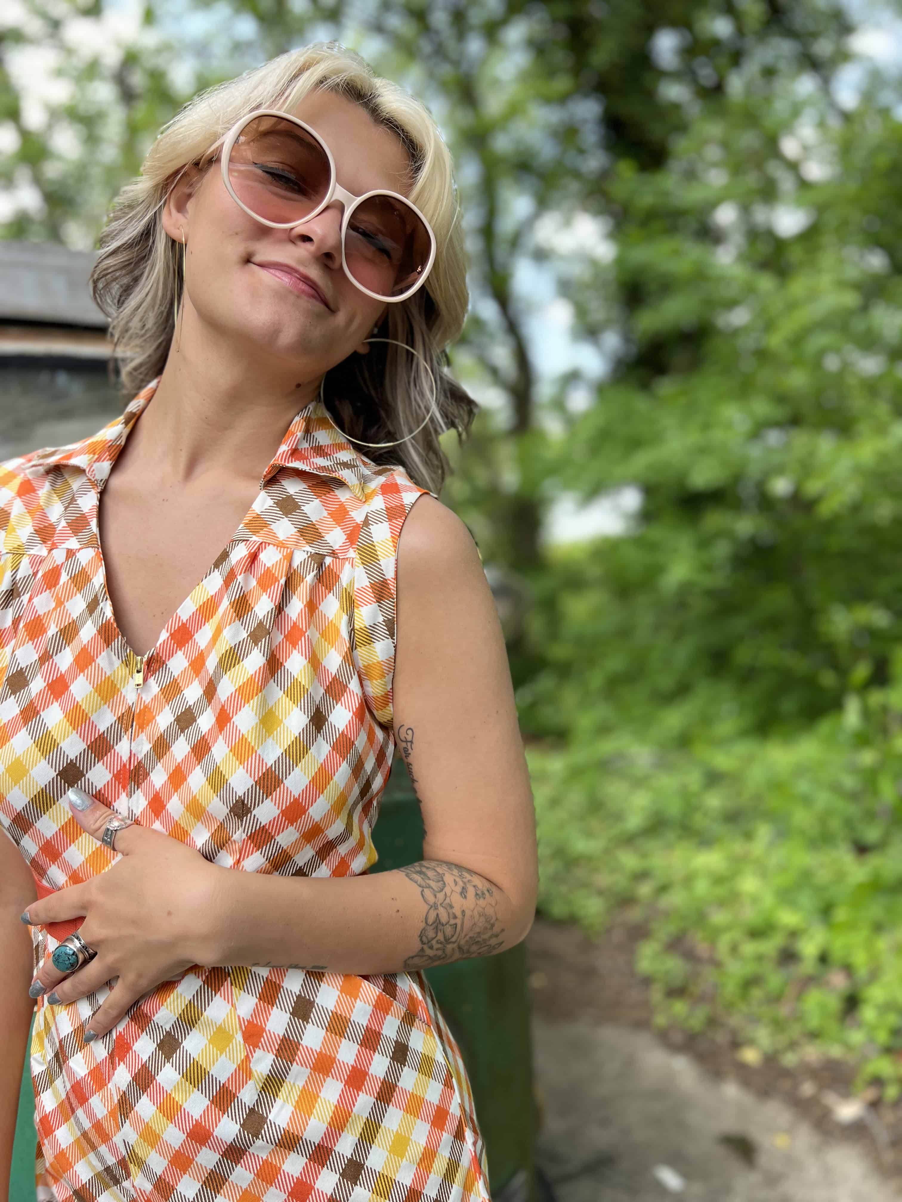 girl in 1970s Gingham Belted Romper in front of green VW vintage bus