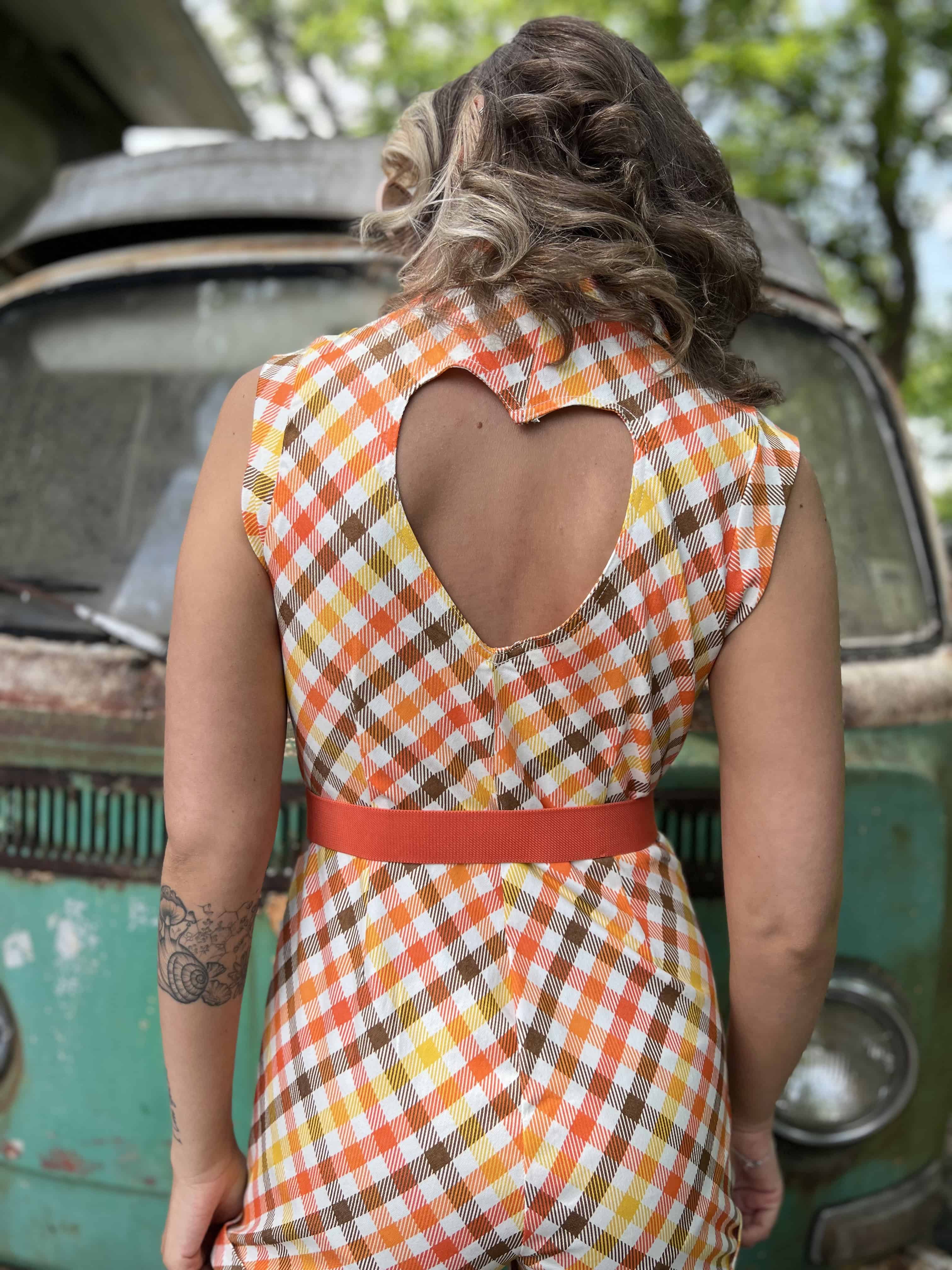 girl in 1970s Gingham Belted Romper in front of green VW vintage bus