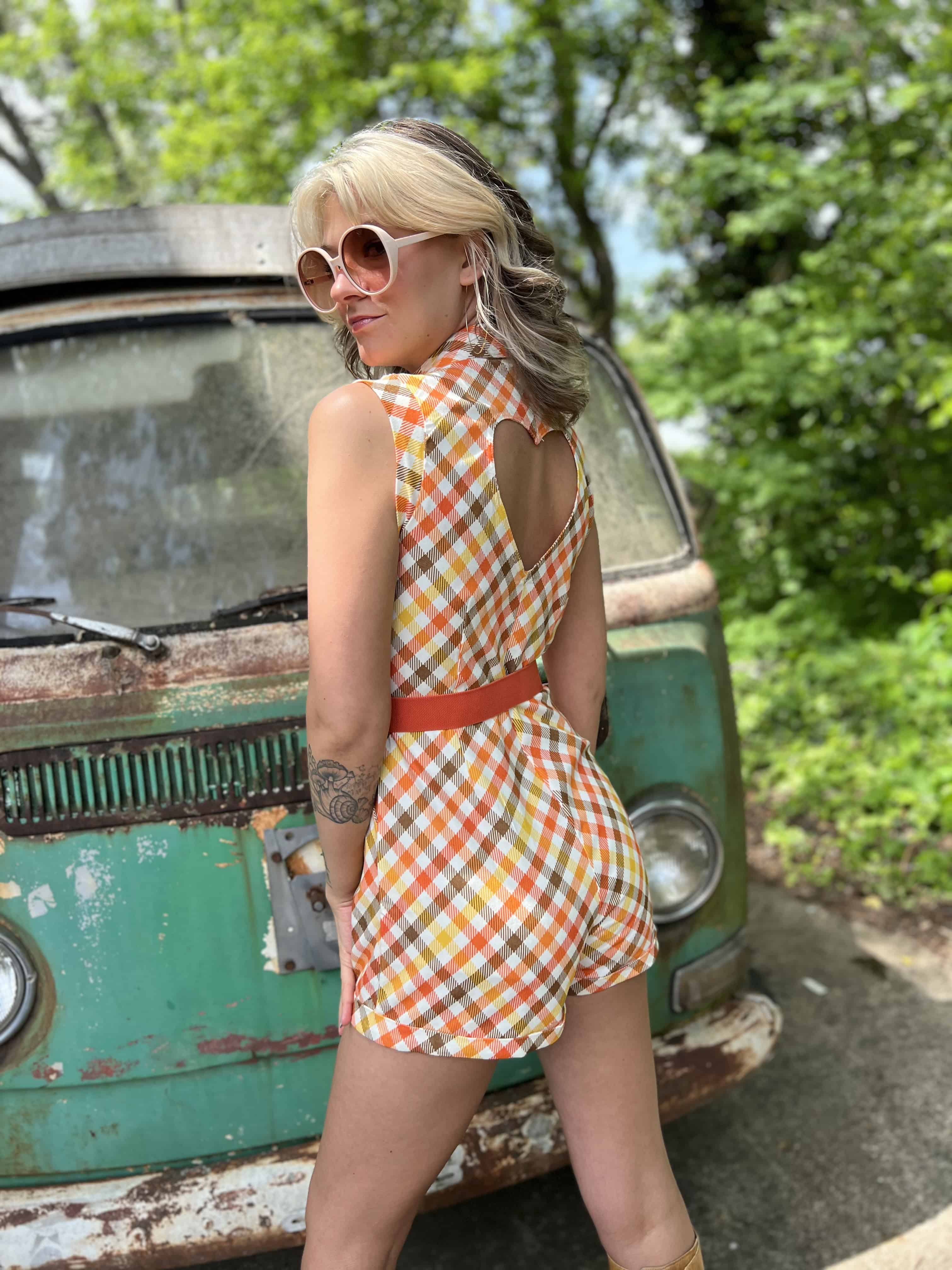 girl in 1970s Gingham Belted Romper in front of green VW vintage bus