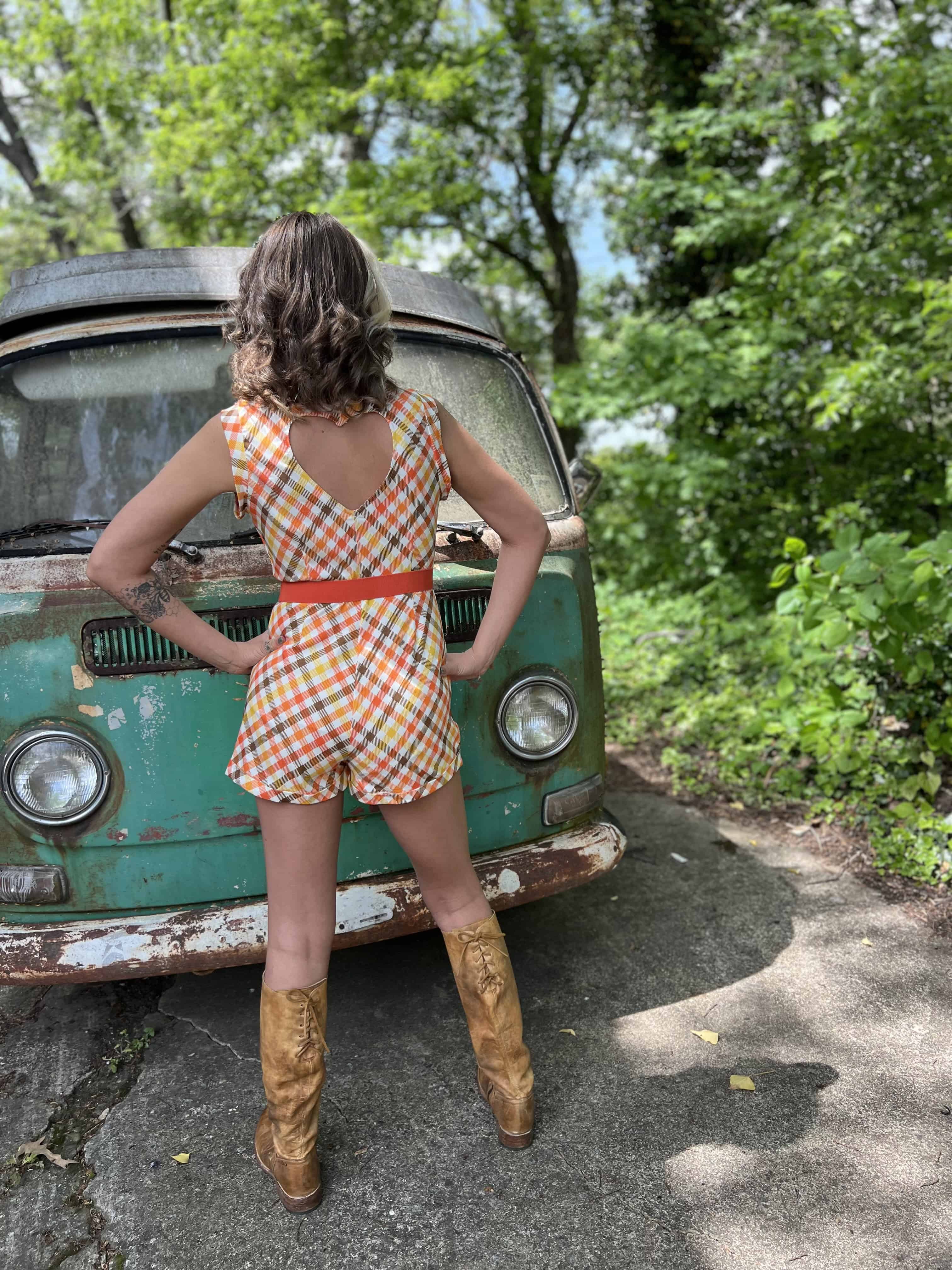 girl in 1970s Gingham Belted Romper in front of green VW vintage bus
