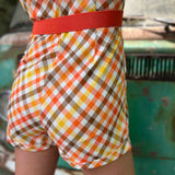 girl in 1970s Gingham Belted Romper in front of green VW vintage bus