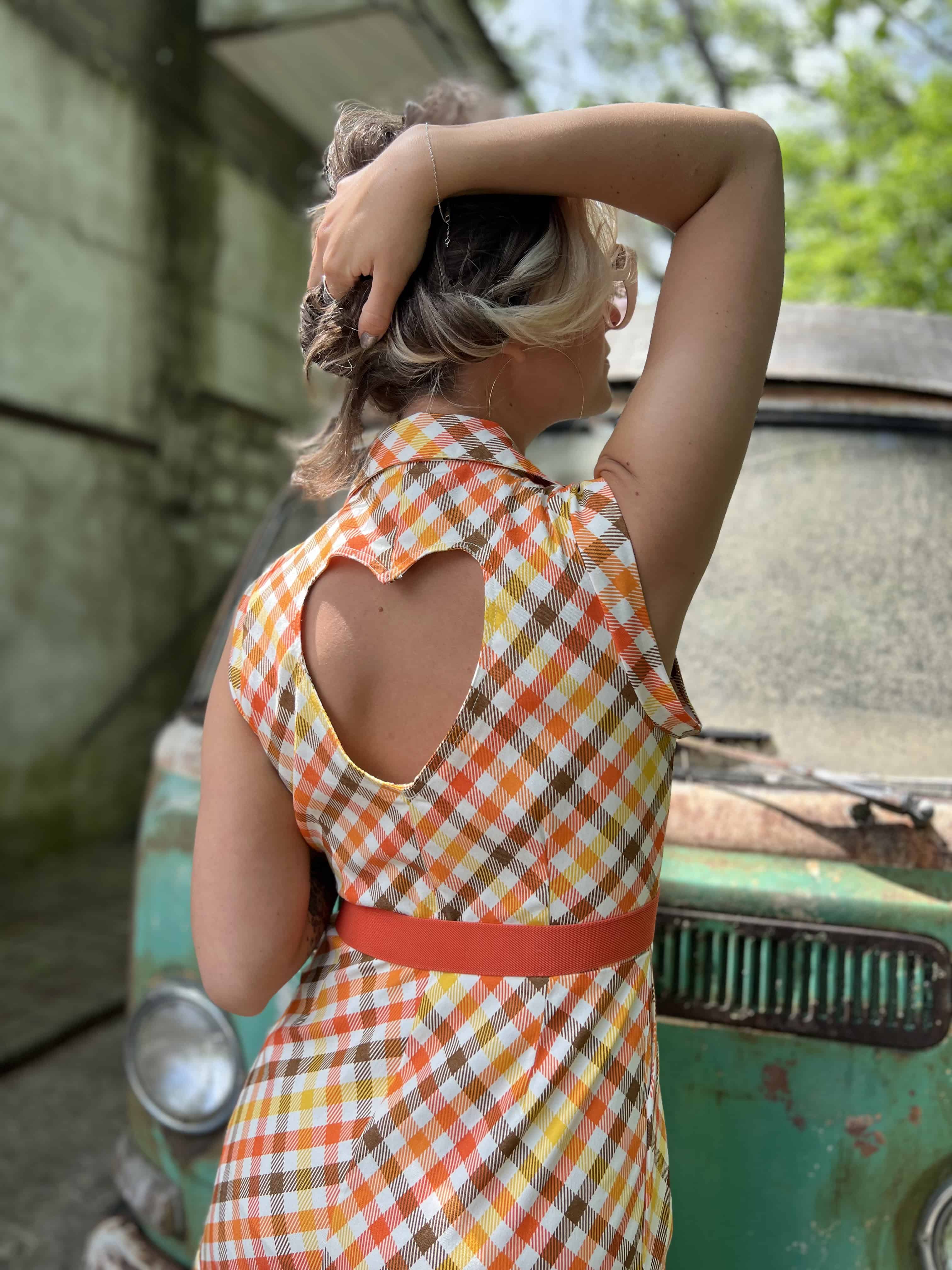 girl in 1970s Gingham Belted Romper in front of green VW vintage bus