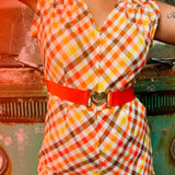 girl in 1970s Gingham Belted Romper in front of green VW vintage bus