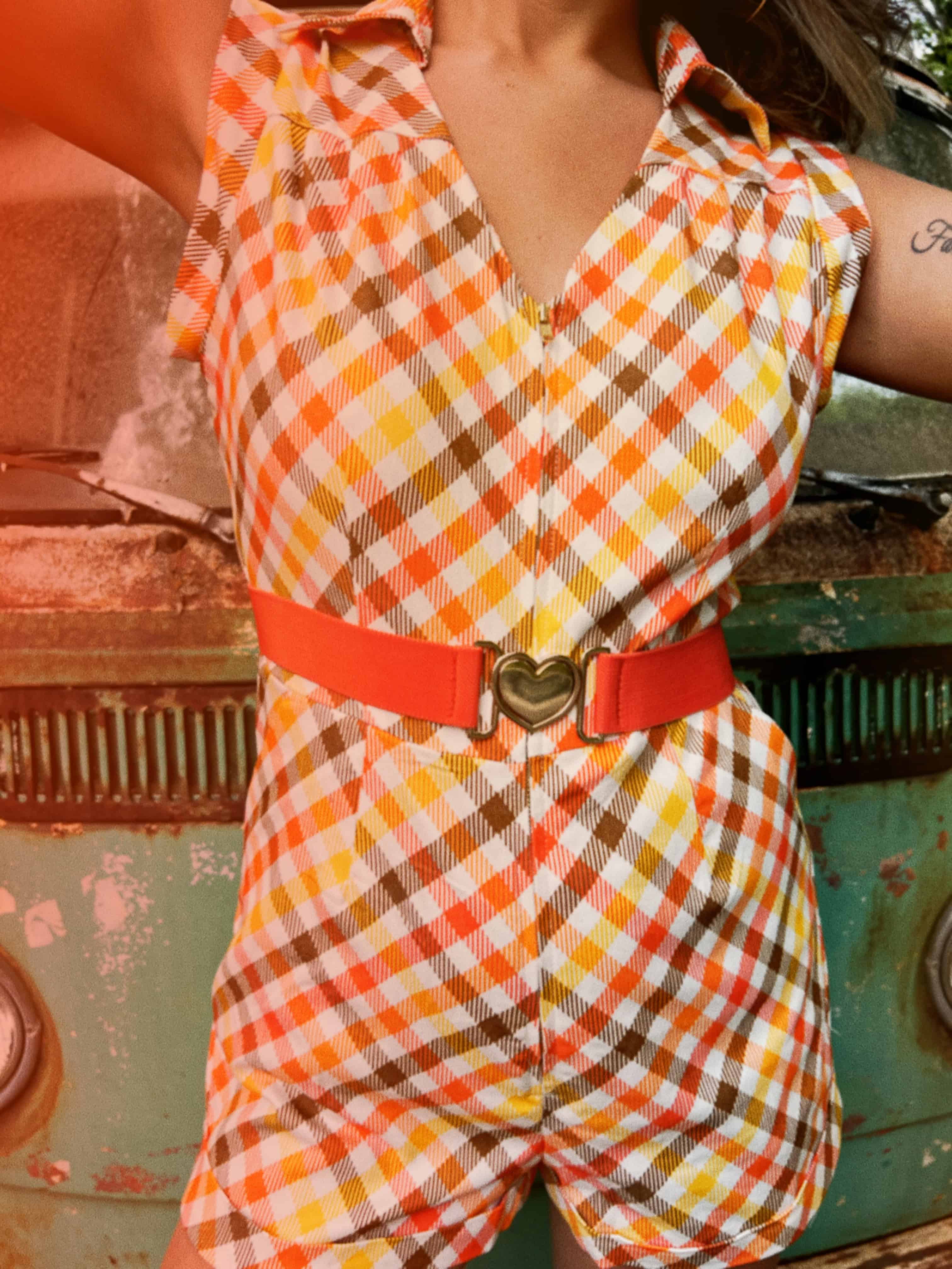 girl in 1970s Gingham Belted Romper in front of green VW vintage bus