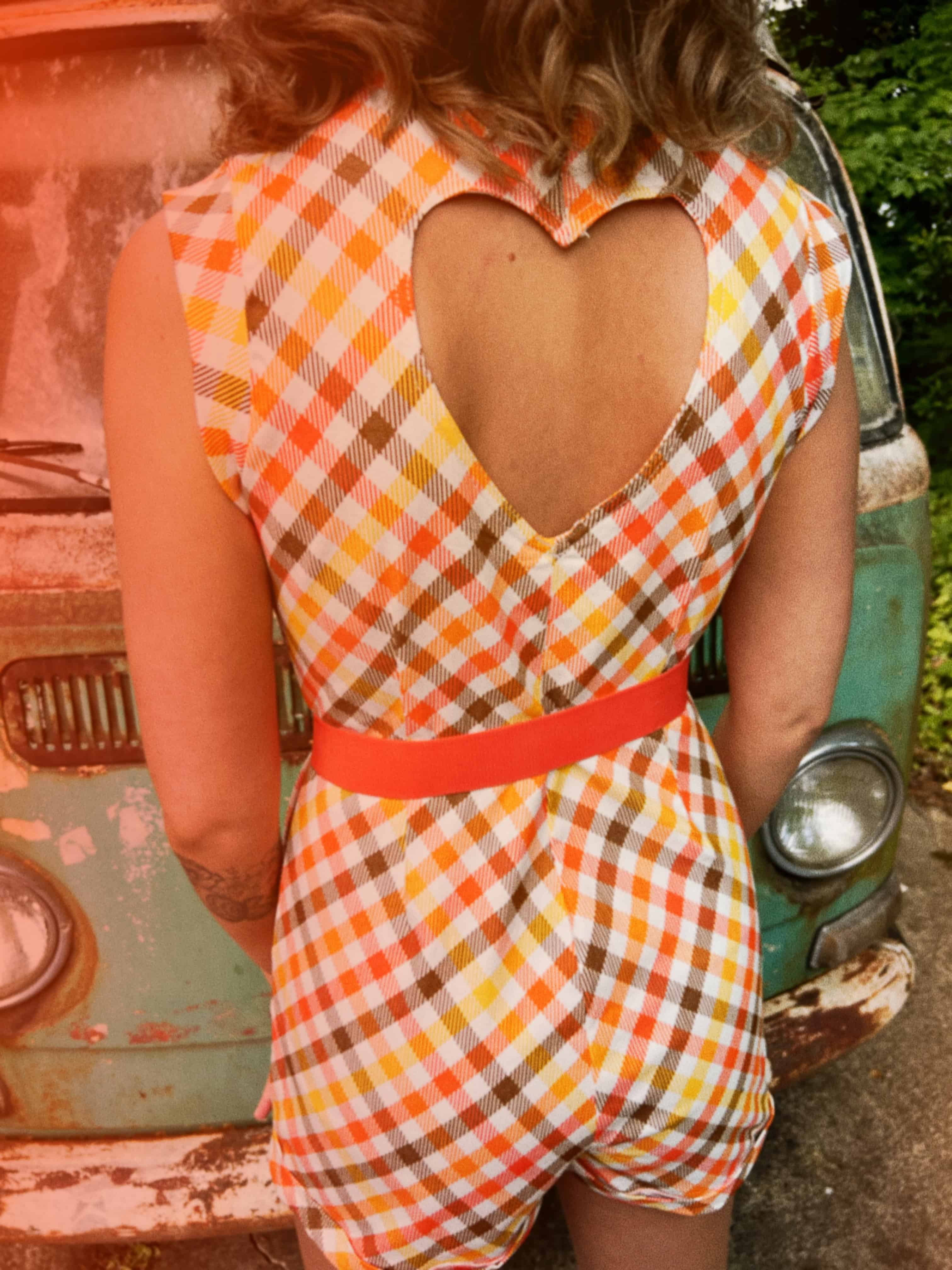 girl in 1970s Gingham Belted Romper in front of green VW vintage bus