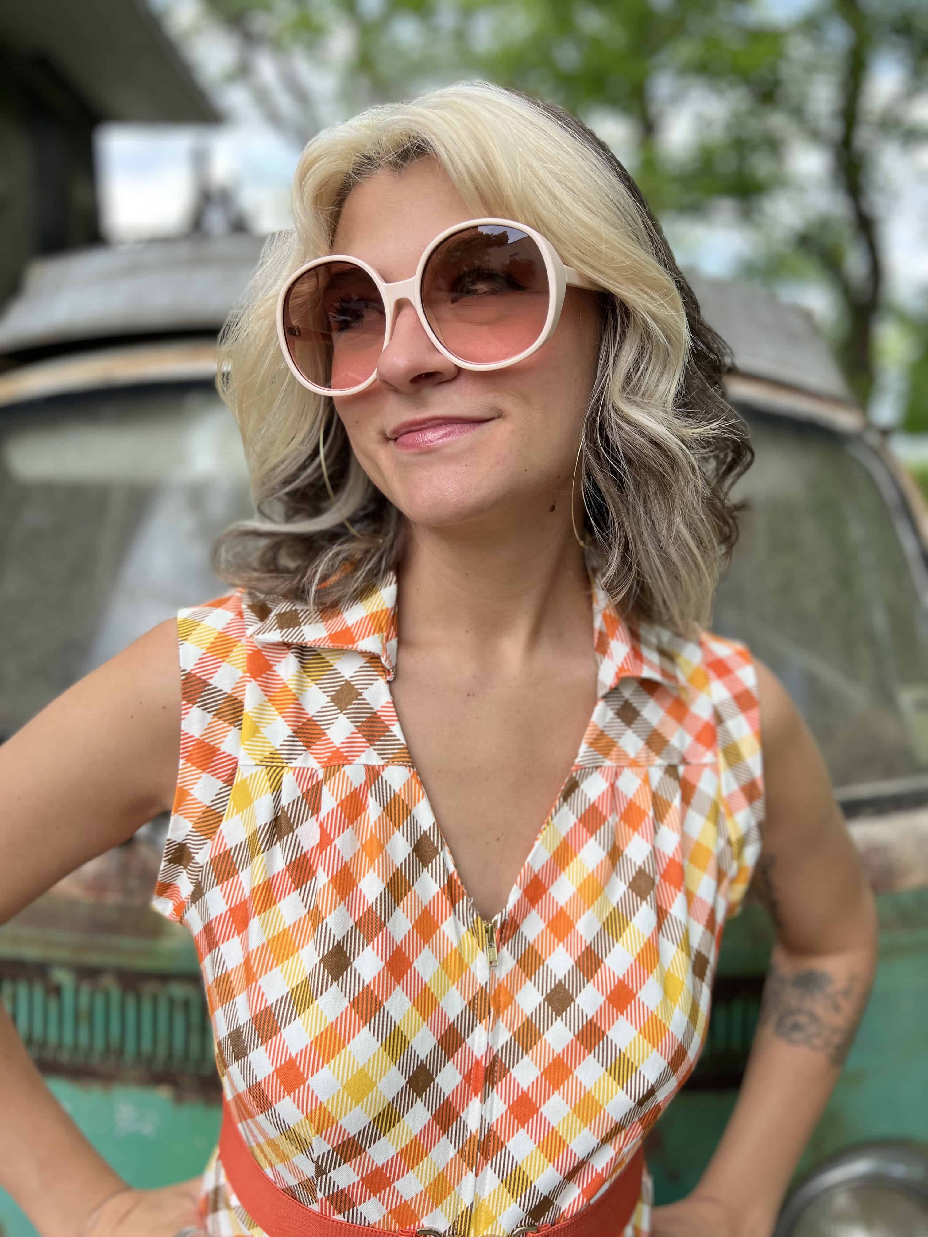 girl in 1970s Gingham Belted Romper in front of green VW vintage bus