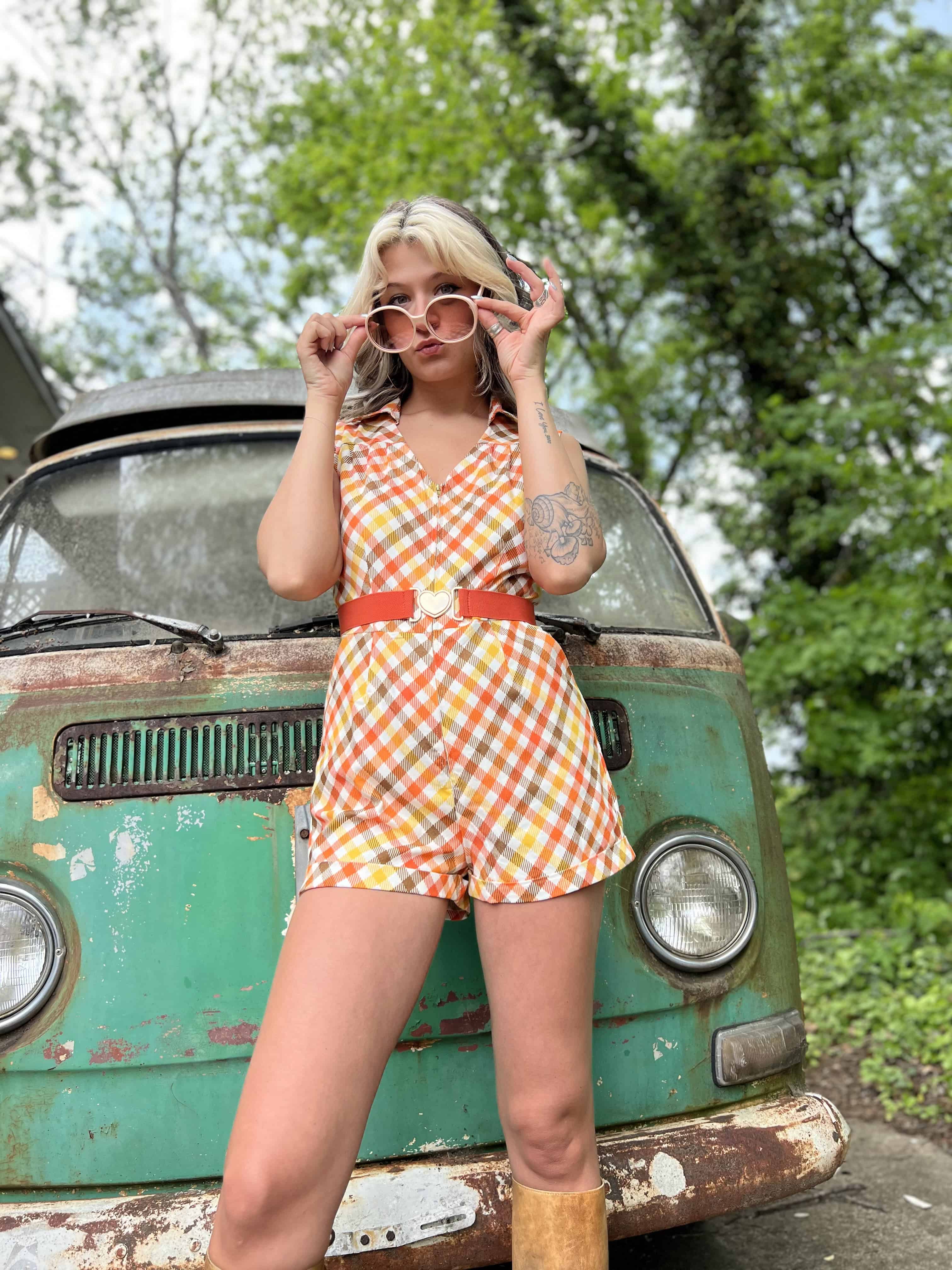 girl in 1970s Gingham Belted Romper in front of green VW vintage bus
