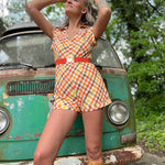 girl in 1970s Gingham Belted Romper in front of green VW vintage bus