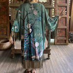 Someone wearing the 1930s Vintage Teal Peacock Fringe Kimono.
