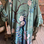 Someone wearing the 1930s Vintage Teal Peacock Fringe Kimono.