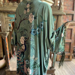 Someone wearing the 1930s Vintage Teal Peacock Fringe Kimono.