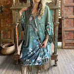 Someone wearing the 1930s Vintage Teal Peacock Fringe Kimono.