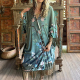 Someone wearing the 1930s Vintage Teal Peacock Fringe Kimono.