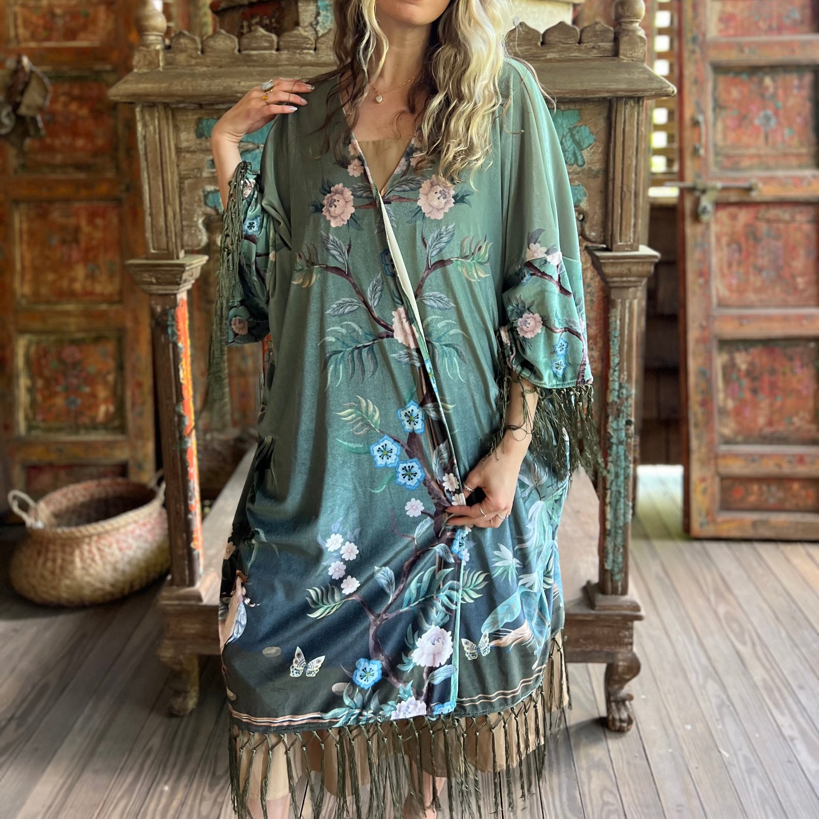 Someone wearing the 1930s Vintage Teal Peacock Fringe Kimono.