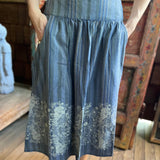 Someone wearing the blue Midnight Floral Midi Skirt.